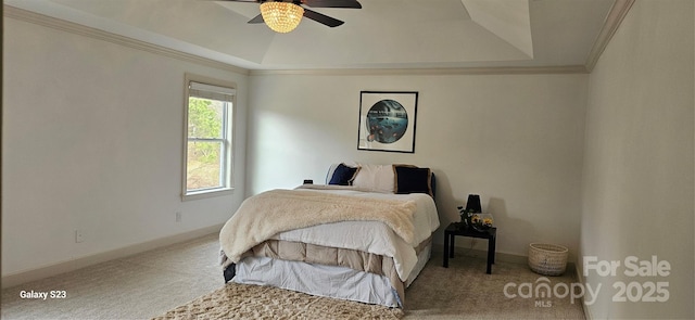 carpeted bedroom with ornamental molding, a tray ceiling, ceiling fan, and baseboards