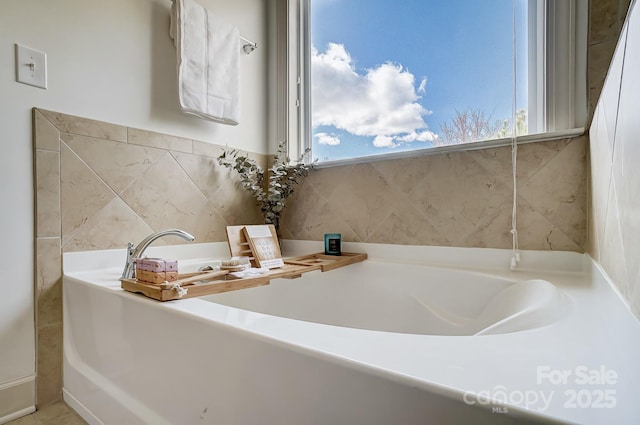 bathroom with a tub to relax in