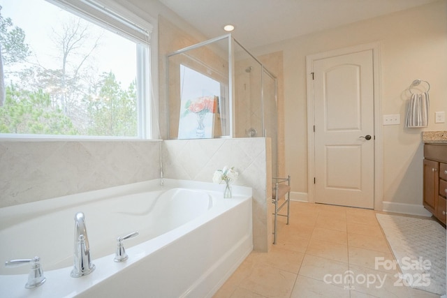 full bathroom featuring a garden tub, tile patterned flooring, vanity, and a stall shower