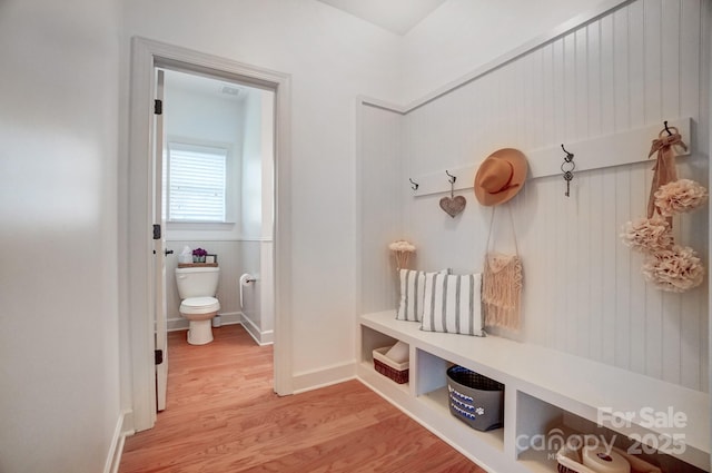 mudroom featuring light wood-type flooring and a wainscoted wall