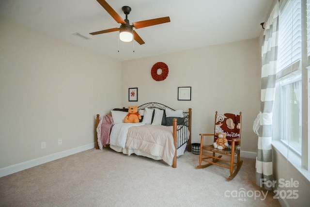 bedroom with multiple windows, carpet, visible vents, and a ceiling fan