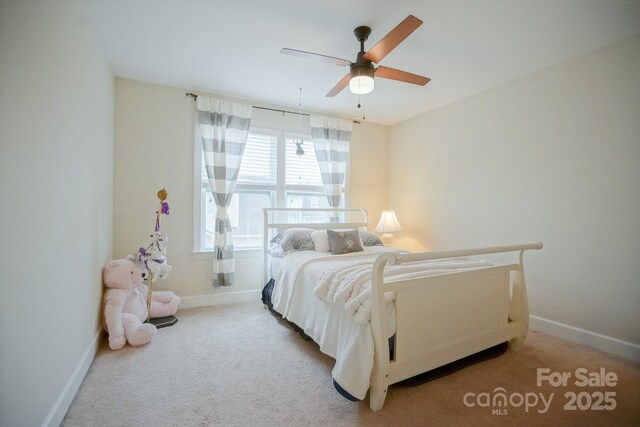 bedroom with carpet, a ceiling fan, and baseboards