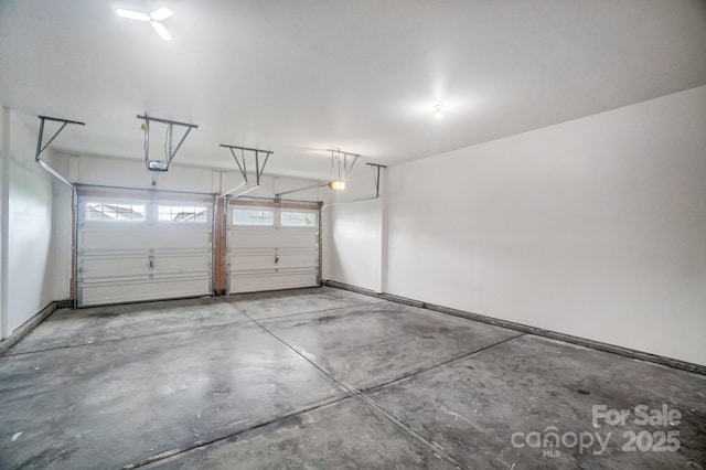 garage featuring a garage door opener and baseboards