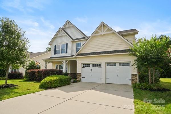 5006 Sand Trap Ct Unit 142, Monroe, NC 28112 - craftsman inspired home with a garage, stone siding, a front yard, and concrete driveway