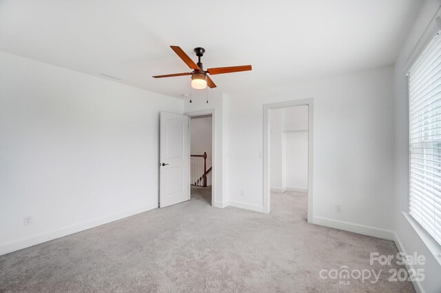 5006 Sand Trap Ct Unit 142, Monroe, NC 28112 - unfurnished bedroom with carpet flooring, a spacious closet, and a ceiling fan