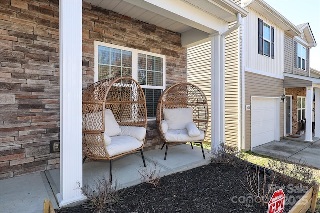 view of patio with a garage and covered porch