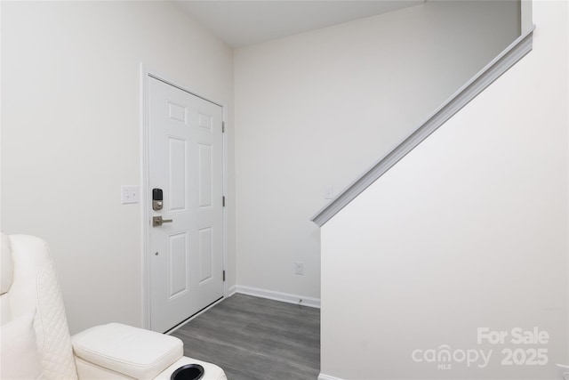 entryway featuring baseboards and dark wood finished floors