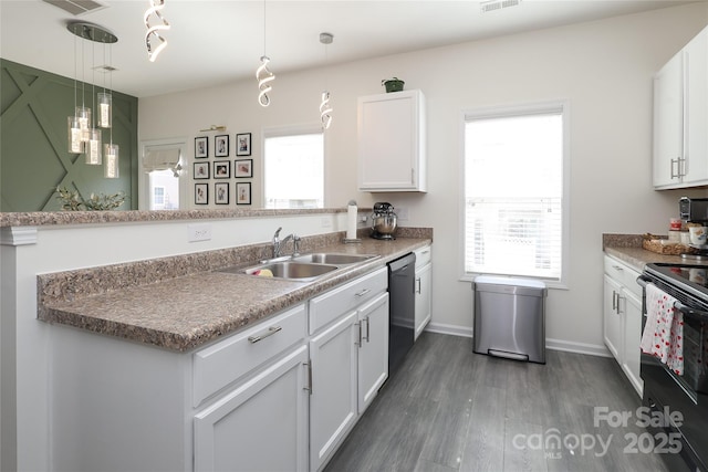 kitchen with black appliances, hanging light fixtures, a sink, and white cabinetry