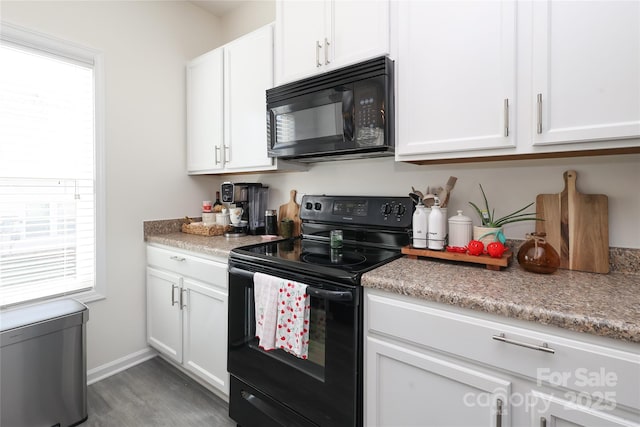 kitchen featuring white cabinetry, baseboards, light countertops, black appliances, and dark wood finished floors