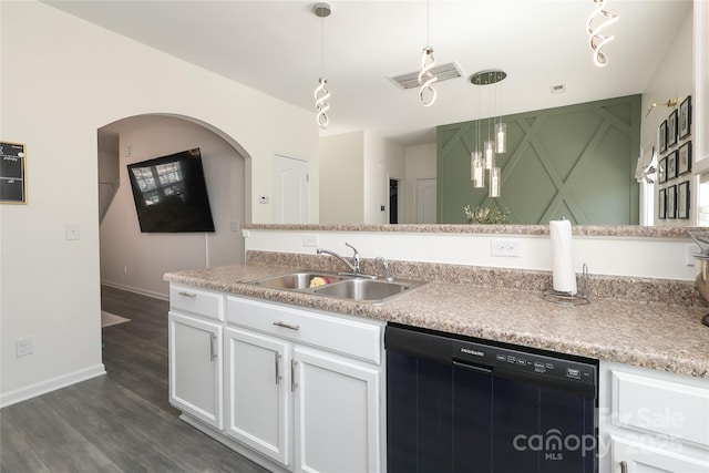 kitchen with white cabinets, a sink, pendant lighting, and dishwasher