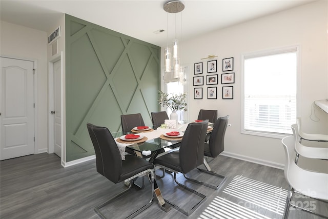 dining area featuring dark wood-style floors, visible vents, and baseboards