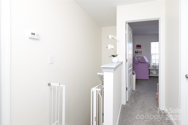 hallway featuring light colored carpet