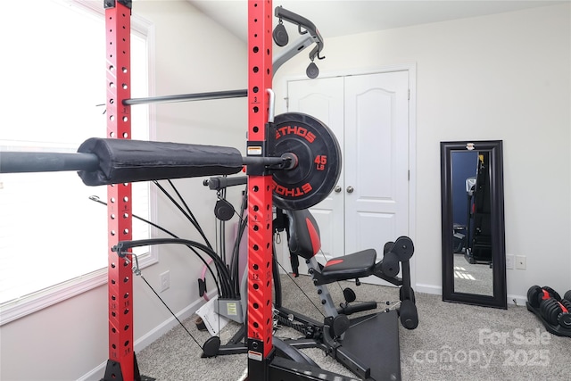 workout area featuring carpet flooring and baseboards