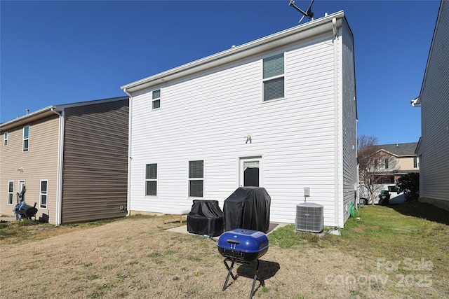 back of property featuring a yard and central AC unit