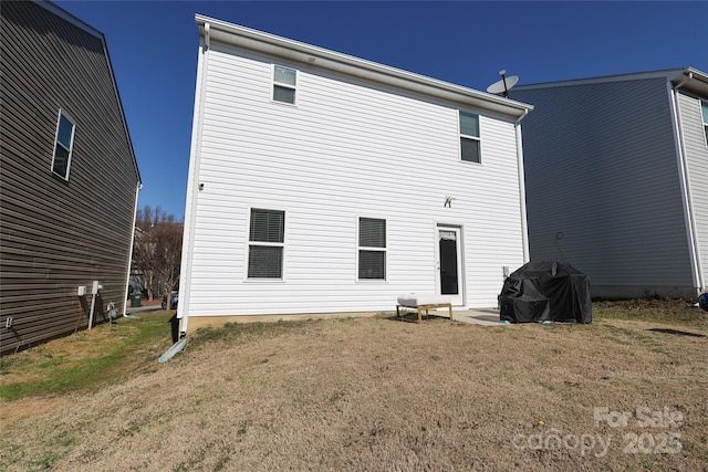 rear view of property featuring a yard