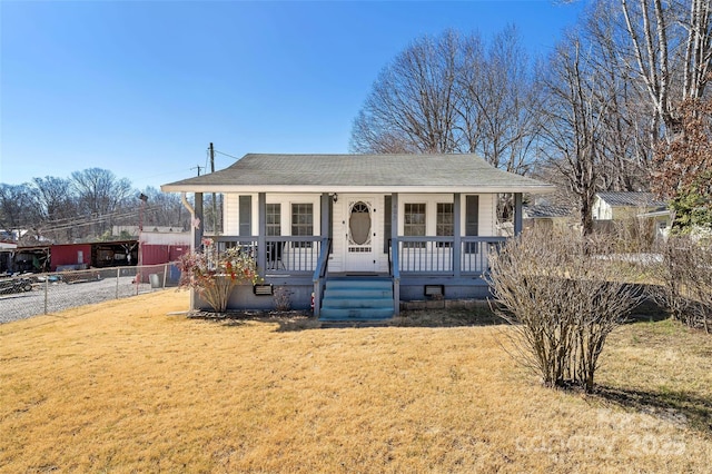 bungalow-style house featuring covered porch, a front yard, and fence