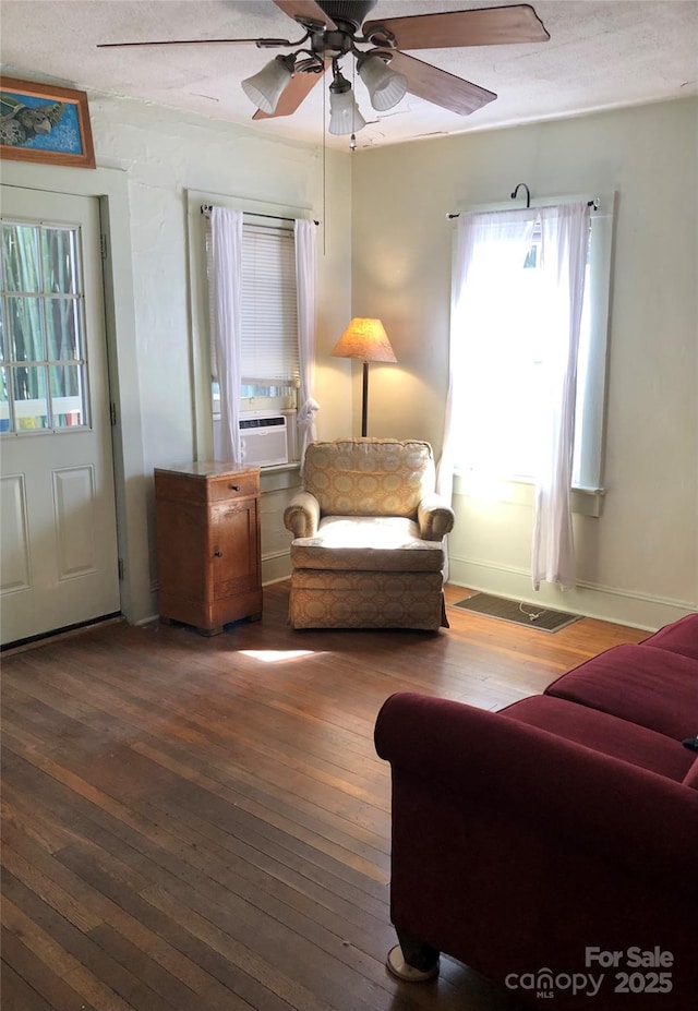 sitting room featuring baseboards, ceiling fan, and hardwood / wood-style floors