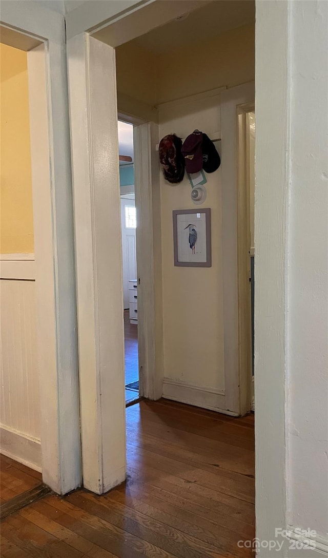 hallway with hardwood / wood-style flooring