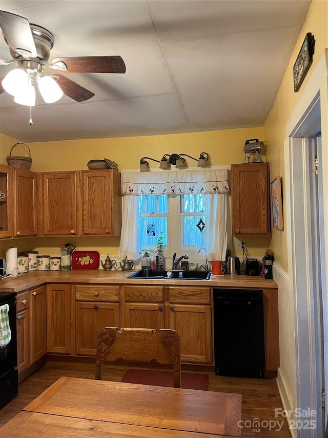 kitchen with a sink, brown cabinets, dishwasher, and wood finished floors