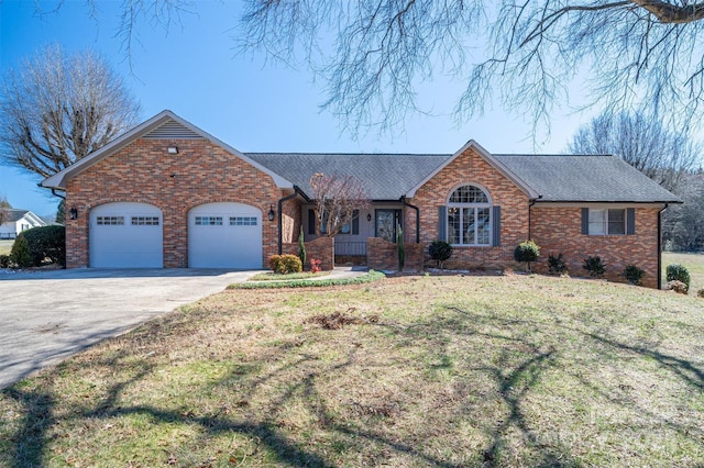 ranch-style home with a front yard, concrete driveway, brick siding, and an attached garage