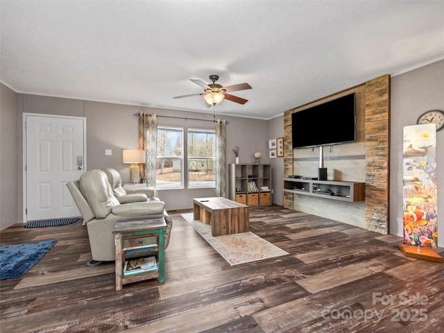 living area featuring ceiling fan, ornamental molding, and wood finished floors