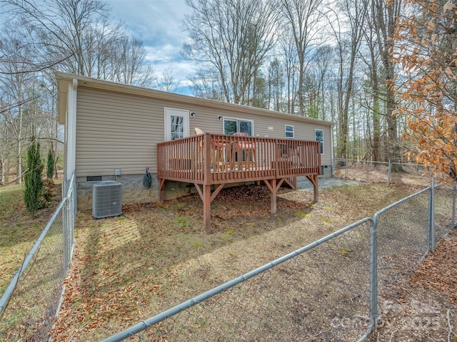 back of house featuring crawl space, a fenced backyard, central AC, and a wooden deck