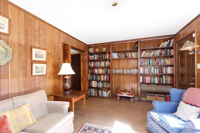 sitting room with light floors and wooden walls