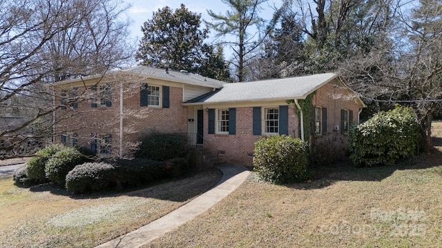 split level home with a front yard, crawl space, and brick siding