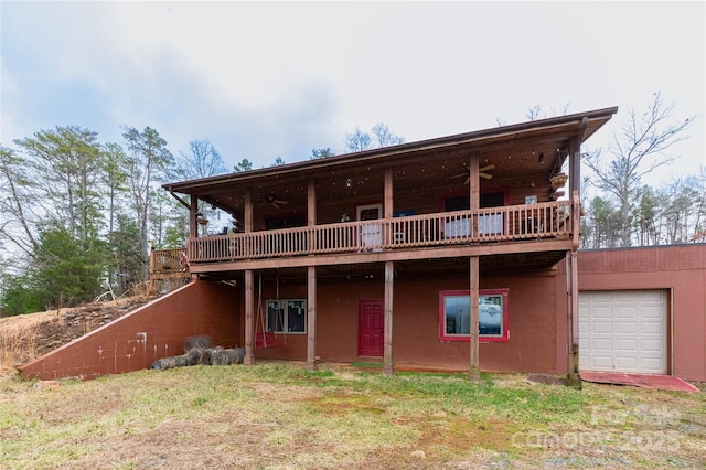 view of front facade featuring a deck, a garage, and ceiling fan