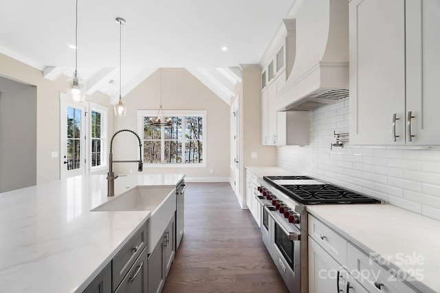 kitchen with stainless steel appliances, white cabinets, custom range hood, light stone countertops, and pendant lighting