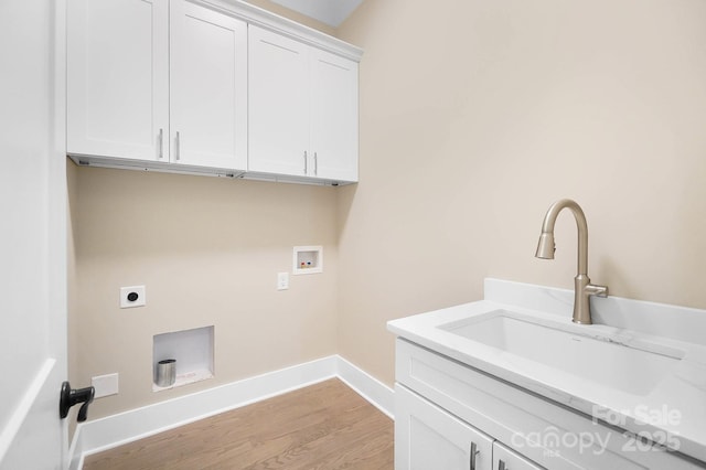 laundry room featuring cabinet space, hookup for a washing machine, electric dryer hookup, light wood-style floors, and a sink