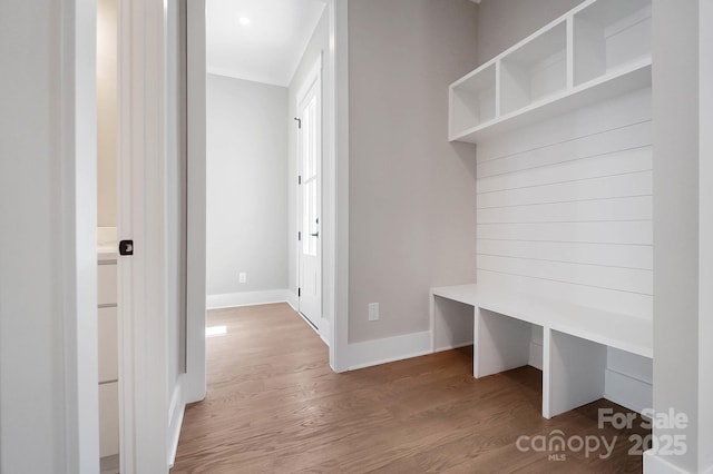 mudroom featuring wood finished floors and baseboards