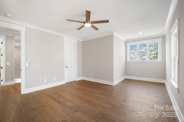 unfurnished room featuring ceiling fan, baseboards, ornamental molding, and dark wood finished floors