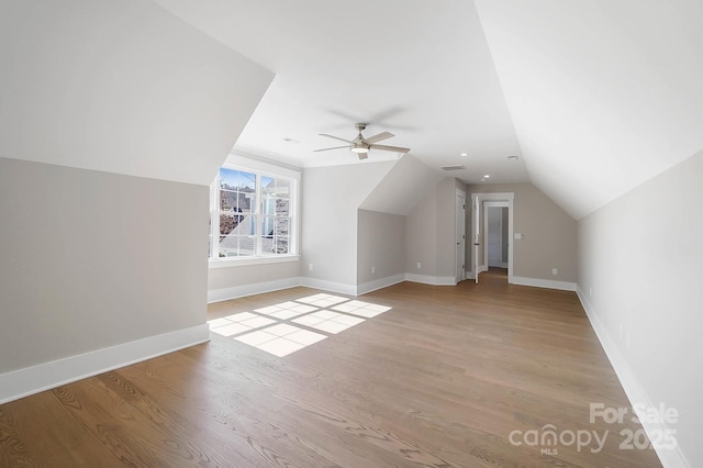 bonus room featuring visible vents, baseboards, ceiling fan, vaulted ceiling, and light wood-type flooring