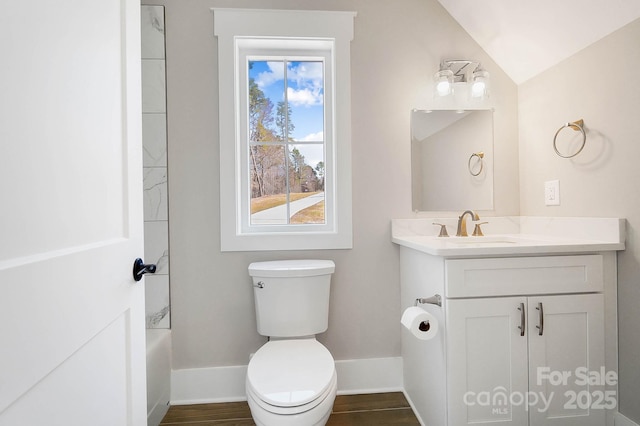 full bathroom with baseboards, toilet, lofted ceiling, wood finished floors, and vanity