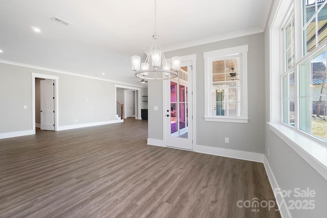 unfurnished dining area featuring baseboards, dark wood-style flooring, and a wealth of natural light