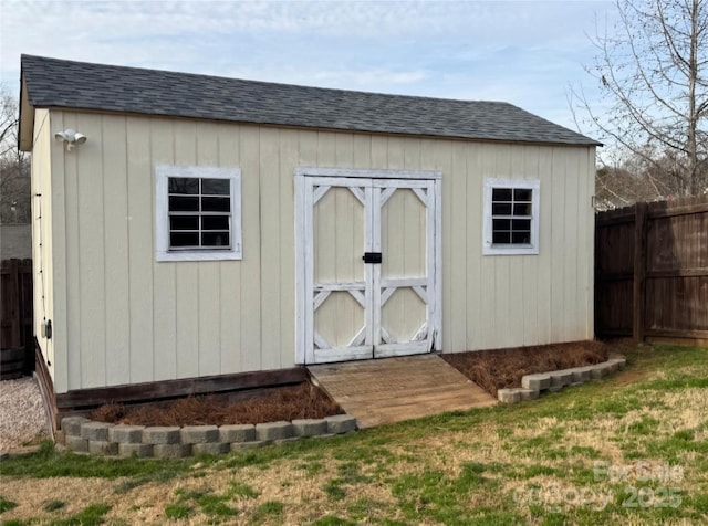 view of shed featuring fence