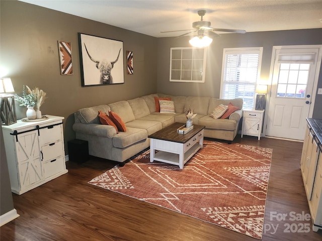 living room with dark wood-type flooring and a ceiling fan