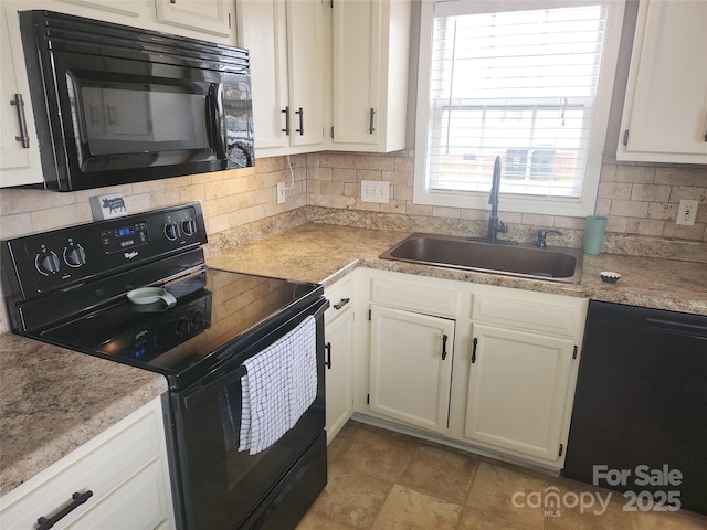 kitchen featuring white cabinets, a sink, backsplash, and black appliances