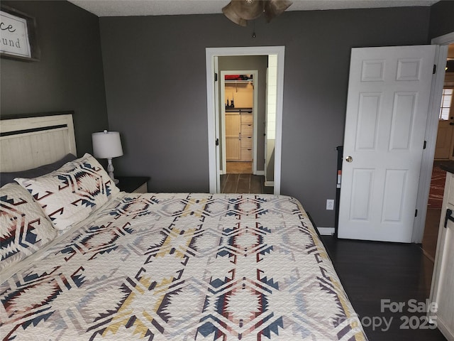 bedroom featuring dark wood-type flooring and baseboards