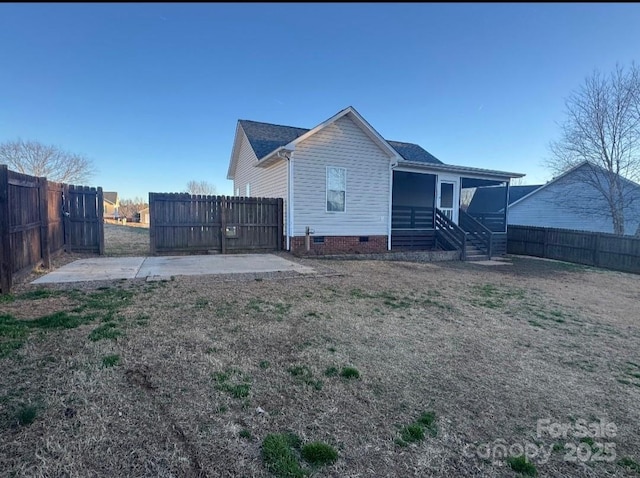 back of house with crawl space and a fenced backyard