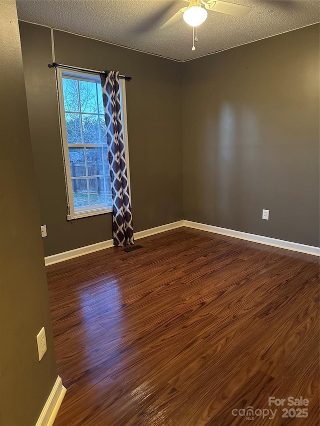 1638 Marmot Pl, Concord, NC 28025 - spare room featuring ceiling fan, dark wood finished floors, a textured ceiling, visible vents, and baseboards