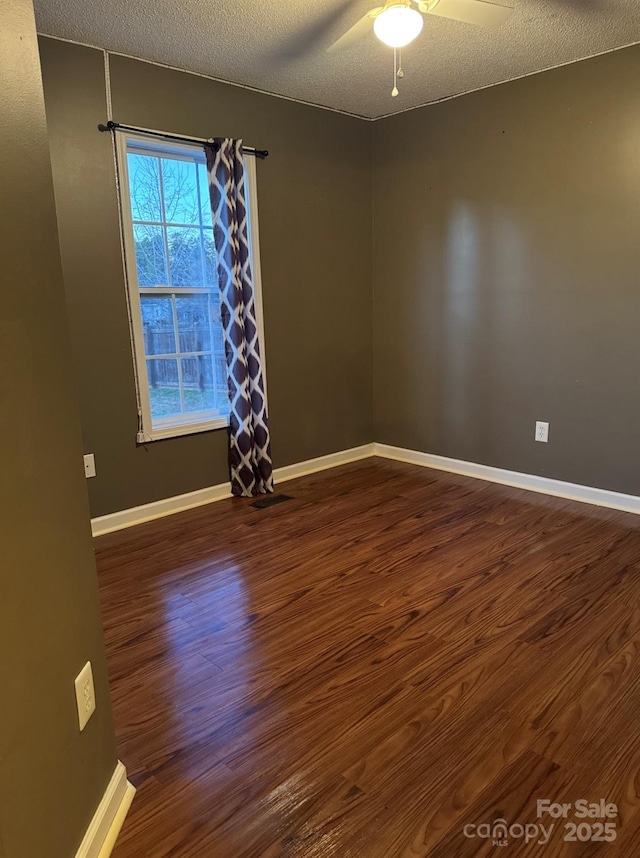 1638 Marmot Pl, Concord, NC 28025 - spare room featuring ceiling fan, a textured ceiling, baseboards, and dark wood finished floors