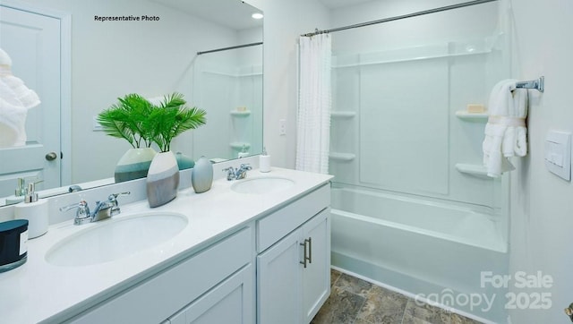 bathroom featuring stone finish flooring, a sink, double vanity, and shower / bathtub combination with curtain