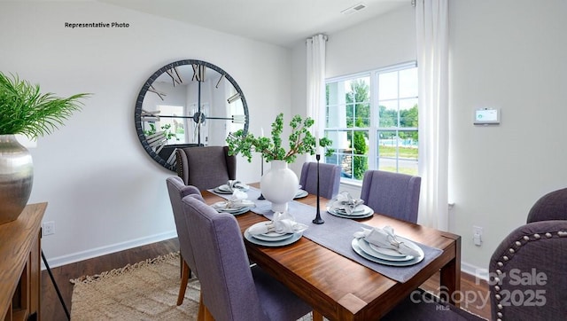 dining room with baseboards, wood finished floors, and visible vents