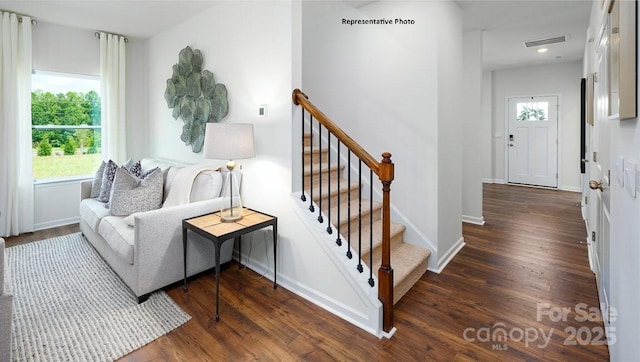 interior space with baseboards, wood finished floors, visible vents, and recessed lighting