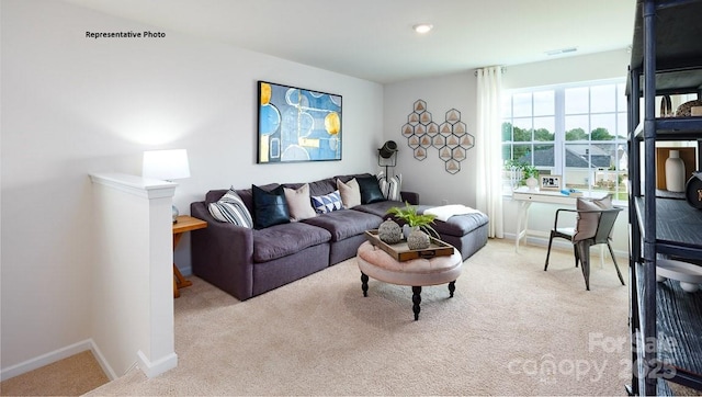 living area with baseboards, carpet flooring, and visible vents