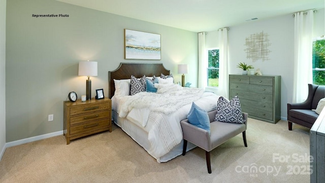 bedroom featuring light carpet and baseboards