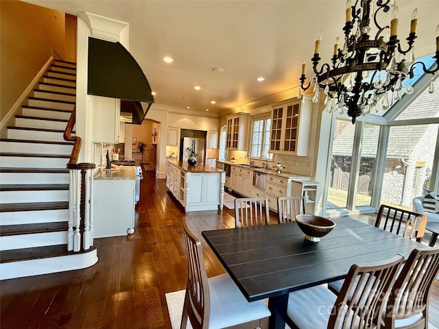 dining space with stairs, dark wood finished floors, a wealth of natural light, and recessed lighting