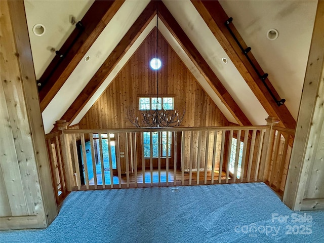 interior space with beam ceiling, high vaulted ceiling, and carpet flooring